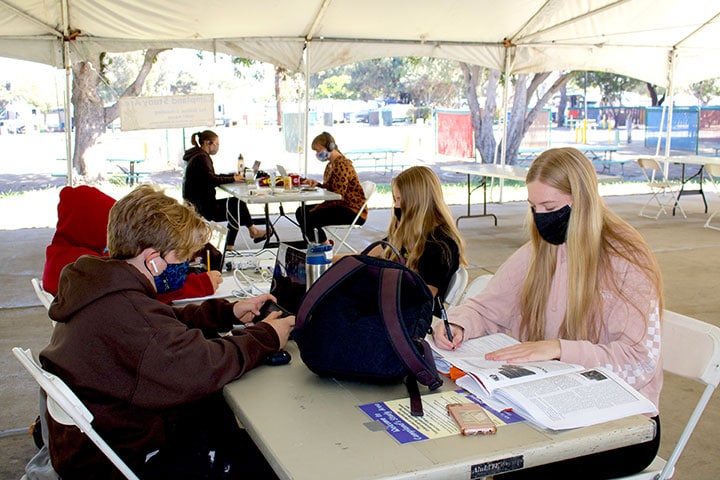 Kids sitting at tables at Open-Air Study Hall at Campland on the Bay RV Resort in San Diego, California