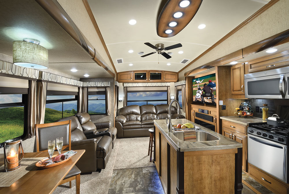 Nice living area inside motorhome with leather couches, kitchen island and table