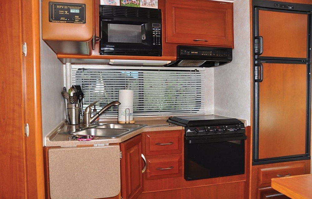The galley makes good use of space, and the flip-up counter extension adds prep area. 