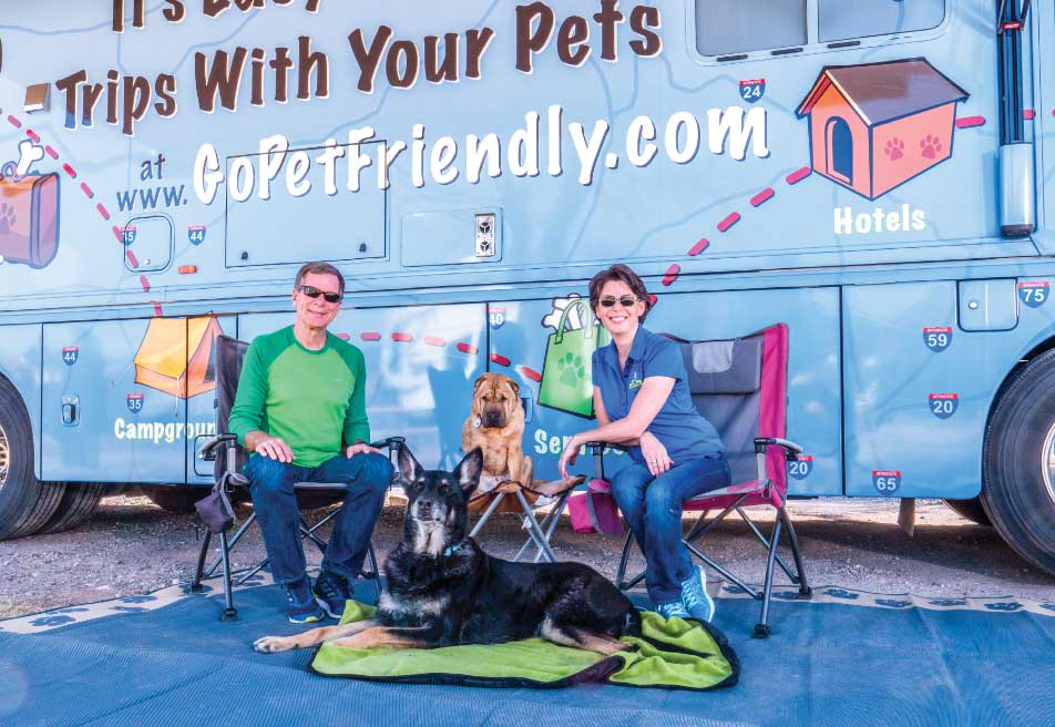 Couple with dogs in front of their Motorhome