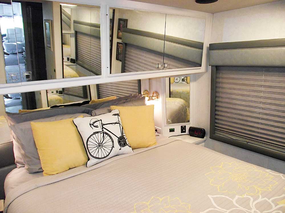 The rear bedroom features mirrored cabinet doors and a roomy queen-size bed.