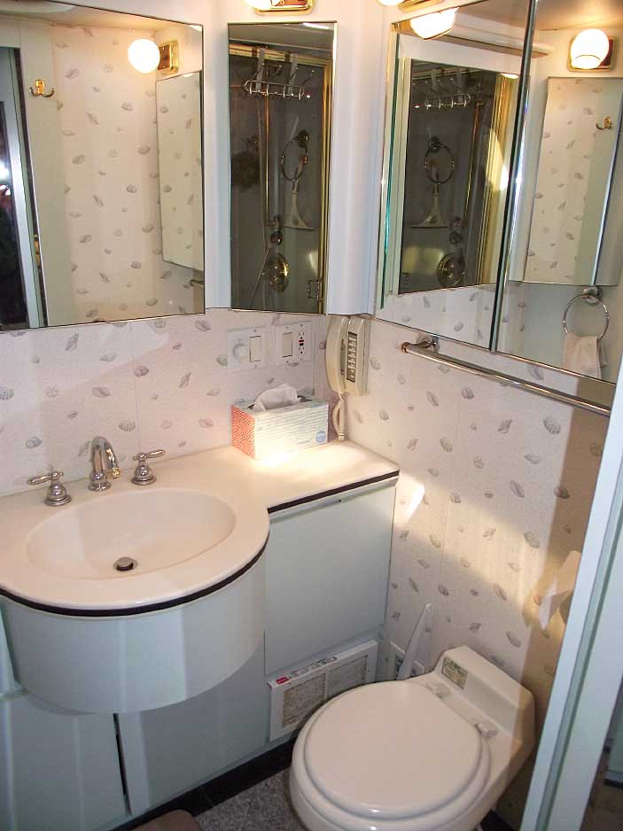 The curved vanity and mirrored cabinets help open up space in the bathroom. 