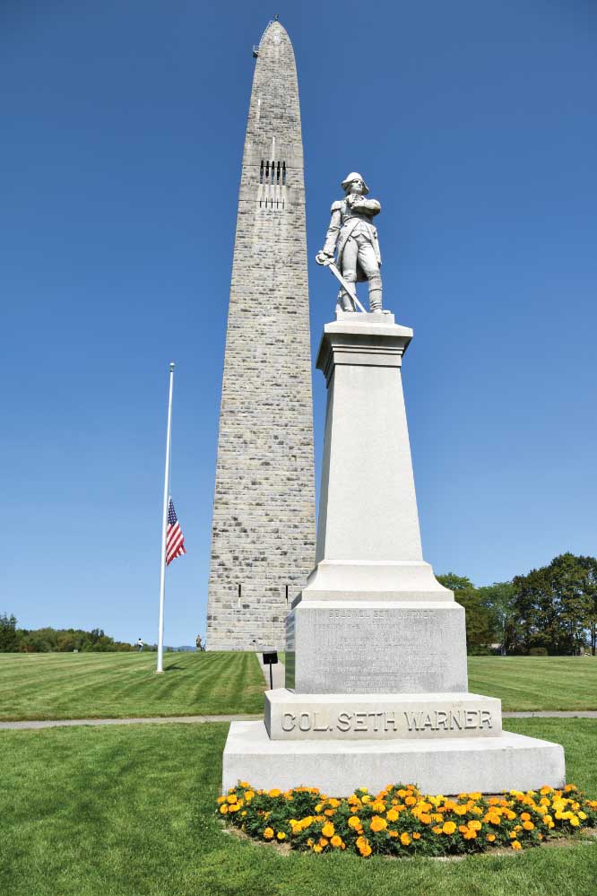 The 306-foot Bennington Battle Monument towers above a statue honoring Revolutionary War colonel and Vermonter Seth Warner.