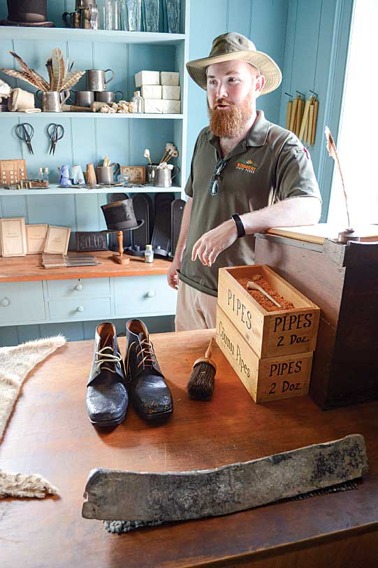 Guide Taylor Harvin “keeps store” at the famous Felix Vallé (Vai-yea) House State Historic Site. Among the furs, candles and shoes is the object in the foreground, an ancient lead ingot.