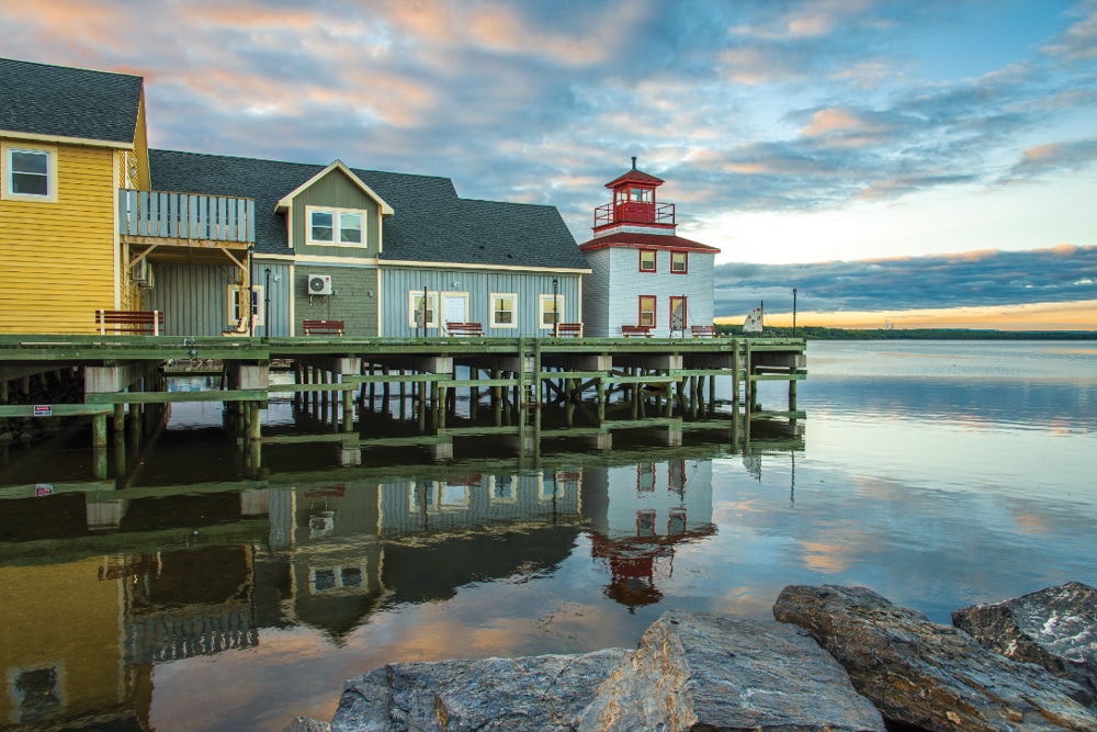 Classic waterfront buildings reflect the peace and tranquility of Pictou Harbor. 