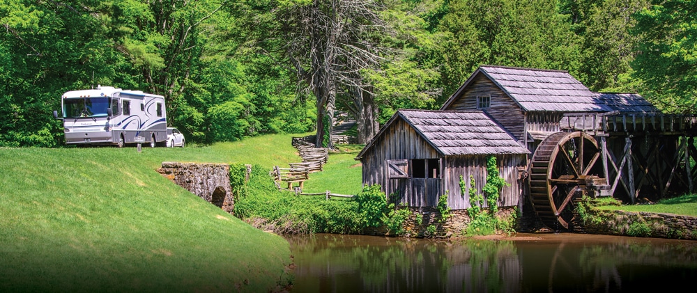 A motorhome drives past Mabry Mill at milepost 176.