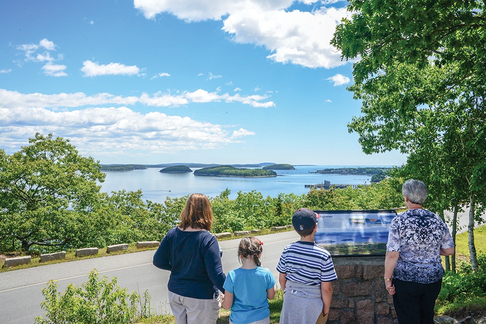 Visitors scan a key to the islands in Frenchman Bay at a stop along the Park Loop Road, which connects Acadia’s lakes, forests, mountains and shores. 