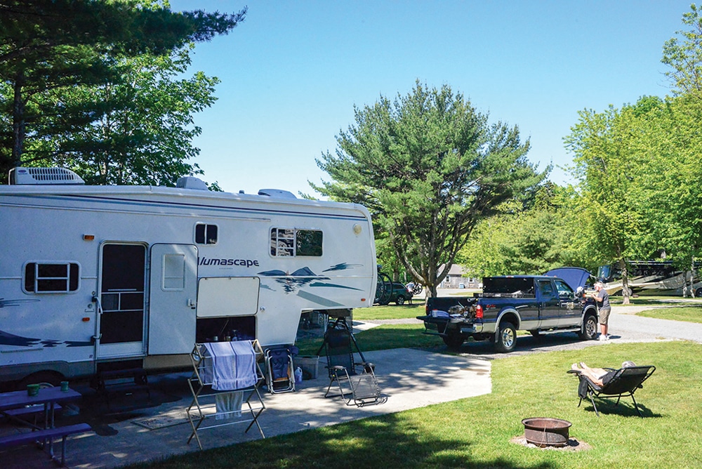 RVers relax and do a minor fix on their truck at Smuggler’s Den Camp­ground, with 47 full-hookup sites, just outside the town of Southwest Harbor. 