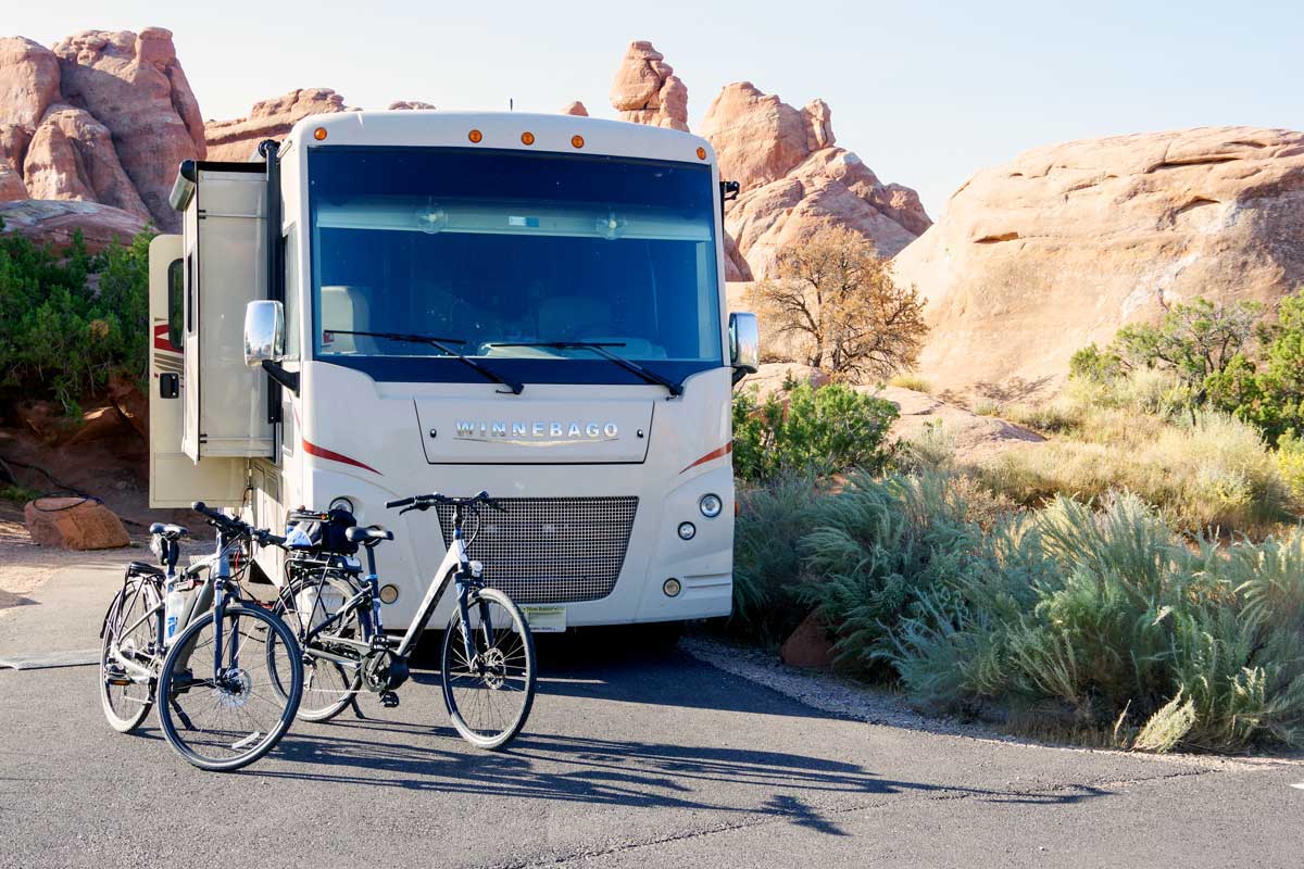 The authors' e-bikes in front of their Winnebago motorhome.