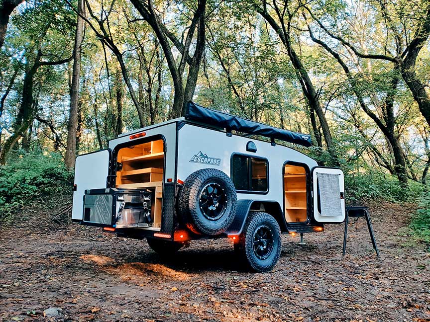 Silver Escapade trailer with doors open at dusk.