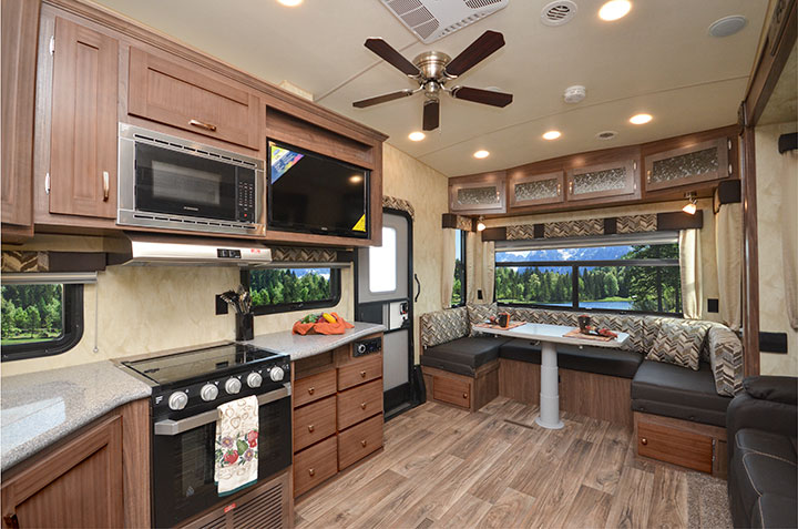 Interior showing kitchen and dinette of Northwood Fox Mountain 265RDS