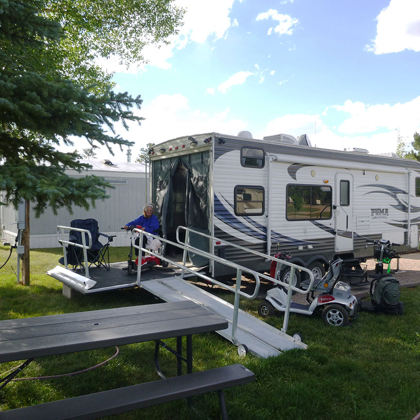 Terri Wilhite on rear ramp of toy hauler in patio position.