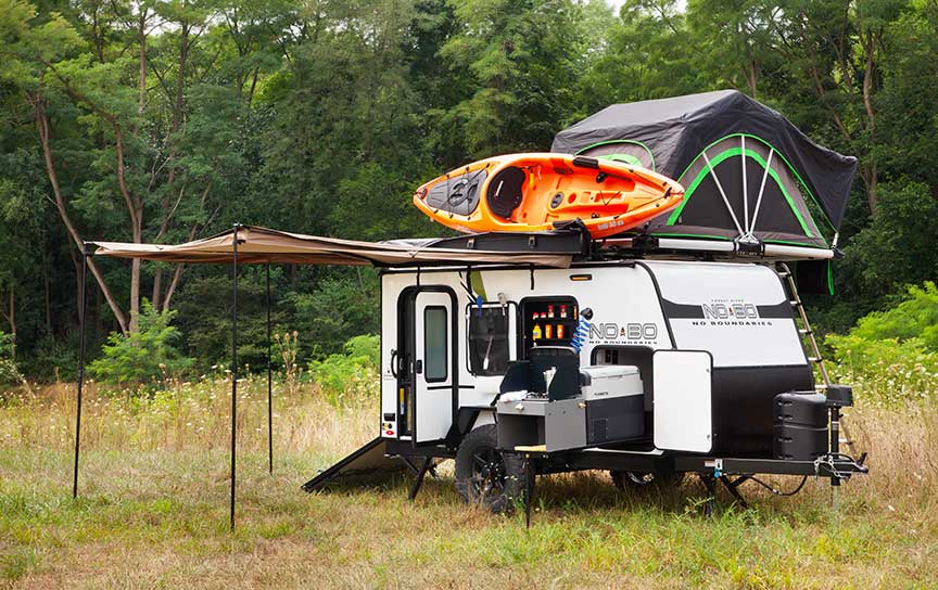 No Boundaries trailer with orange kayak and rooftop tent.