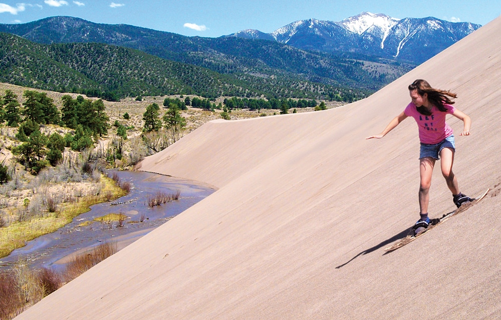 Sandboards made for the dry slopes in Great Sand Dunes National Park and Preserve are more effective than traditional snowboards. 