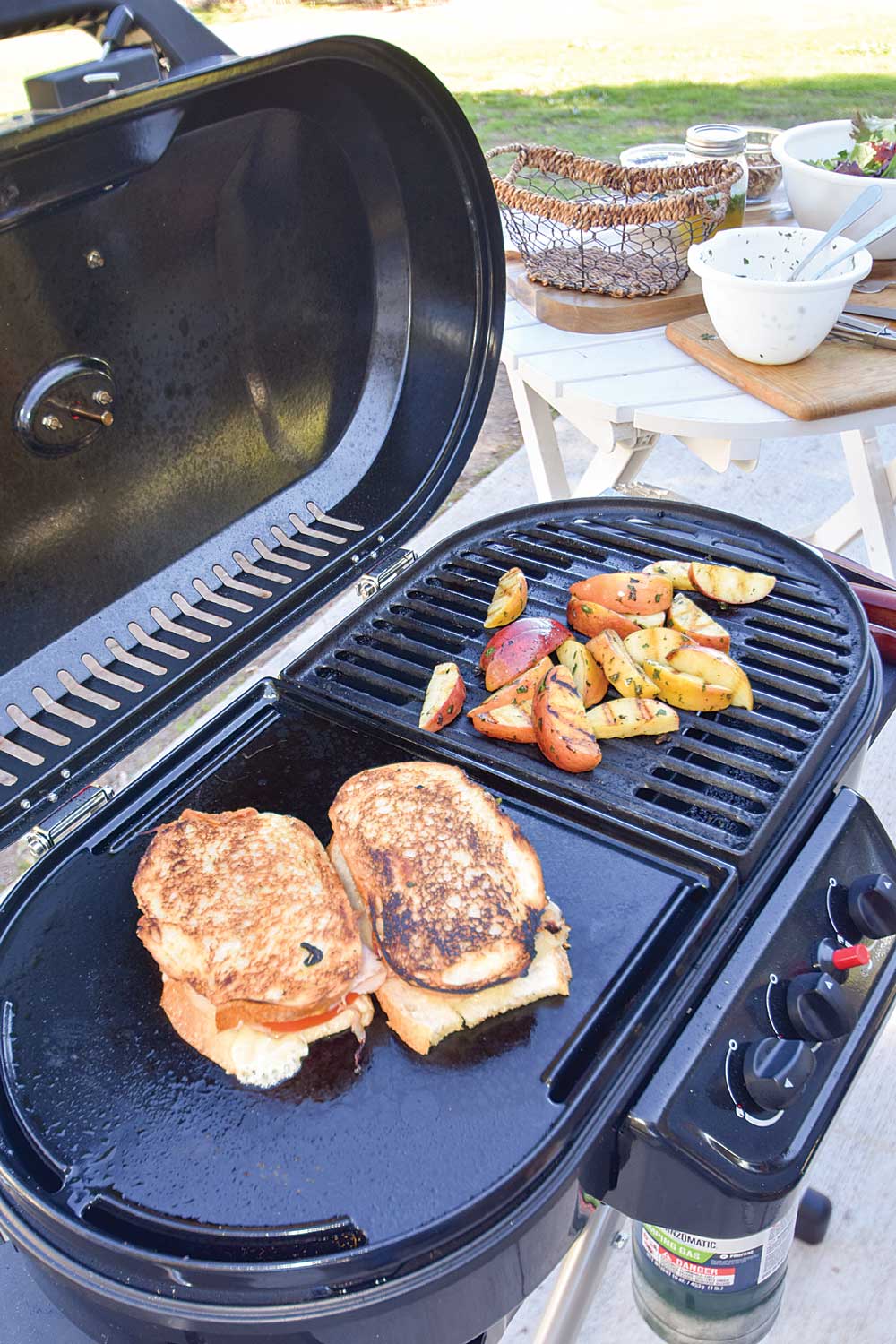 With grilled cheese sandwiches on the griddle side and apple wedges for the salad on the grill side, the Coleman RoadTrip is the stage for the Dawson lunch.