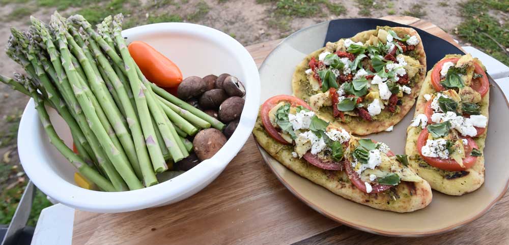 Flatbread pizzas are staged grillside