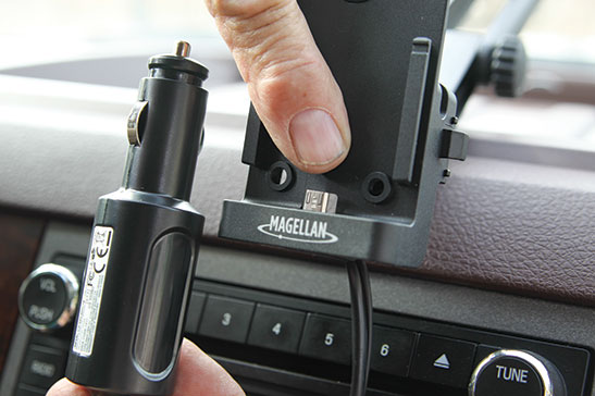An articulating arm with suction cup holds the mounting bracket firmly to the windshield. The plug goes into a nearby 12-volt DC accessory power port.