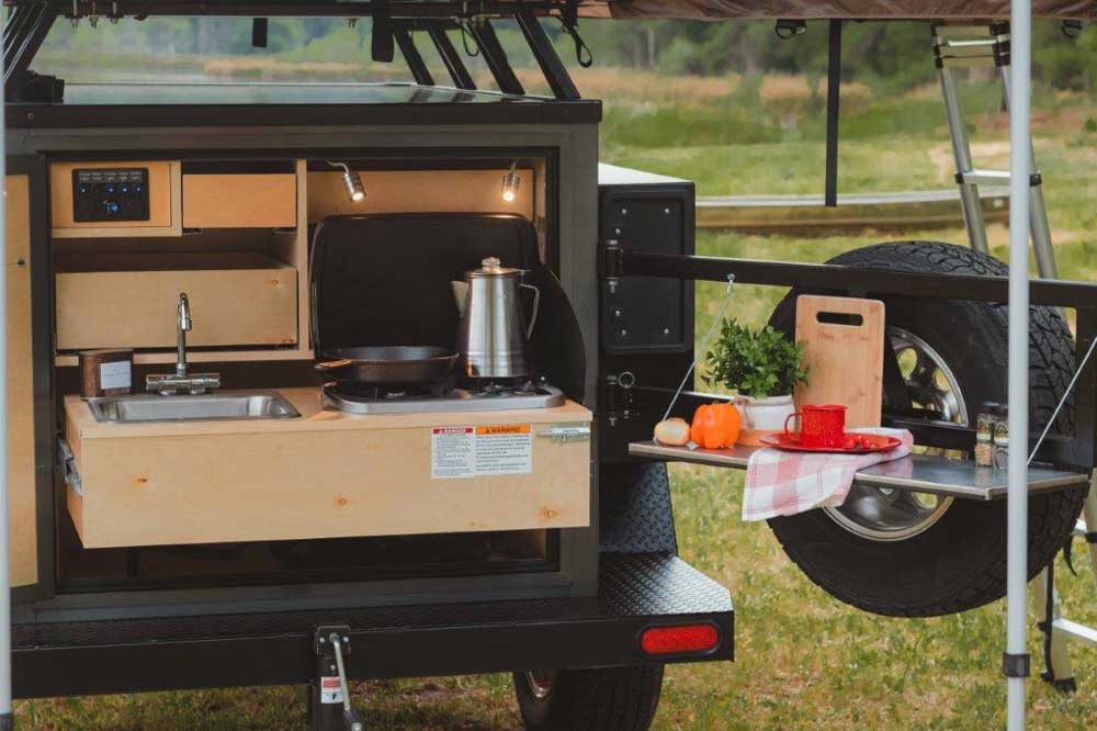 Hoooroo Joey travel trailer outdoor kitchen with swing arm prep table