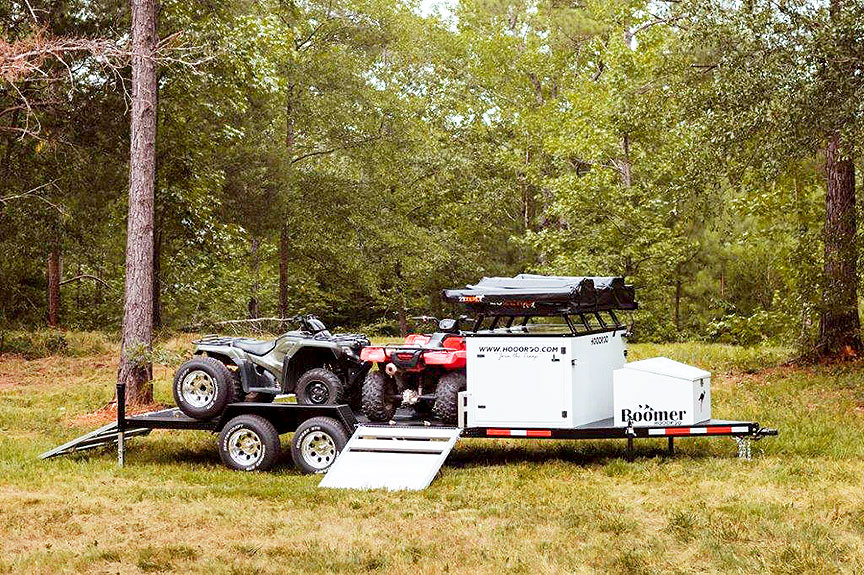 Boomer trailer on grass with two ATVs.