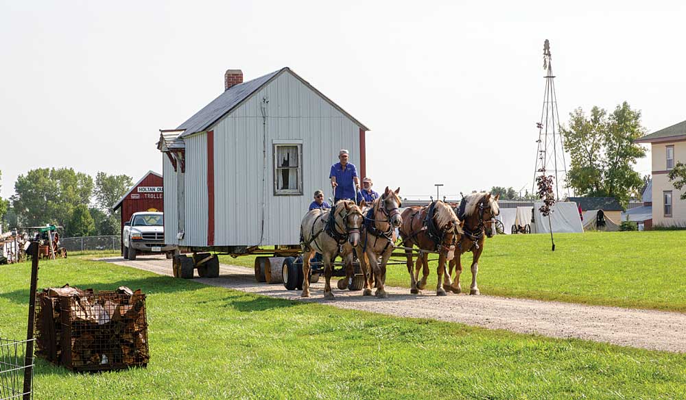 Horses pull a house in the Horse and Mule Event, one of several special events held at Heritage Park of North Iowa.