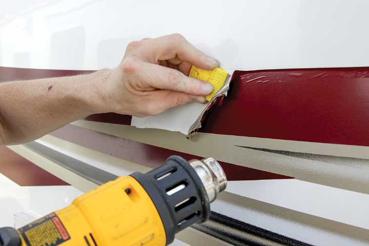 A heat gun softens the vinyl to make it possible to remove the old material.