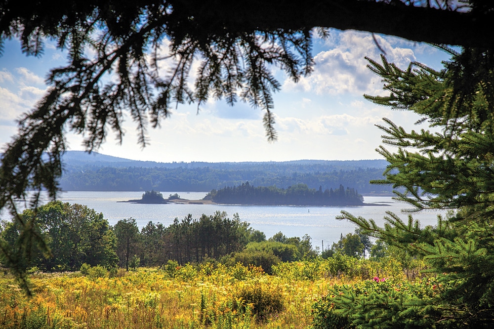 View Saint Croix Island from the Canadian International Historic Site alongside the Fundy Coastal Drive. The United States National Park Service also recognizes the significance of Saint Croix Island with an international historic site, complete with visitor center and interpretive trail featuring bronze statues, located near Calais, Maine.