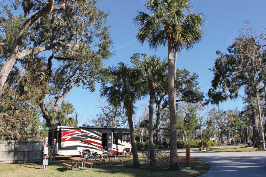 A motorhome in a campsite at Daytona’s Endless Summer Campground.