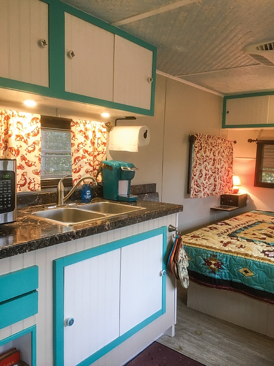 Even though the owners cook most of their meals outdoors, the well-thought-out kitchen is a functional and comfortable layout for year-round living and matches the look of the rest of the trailer.