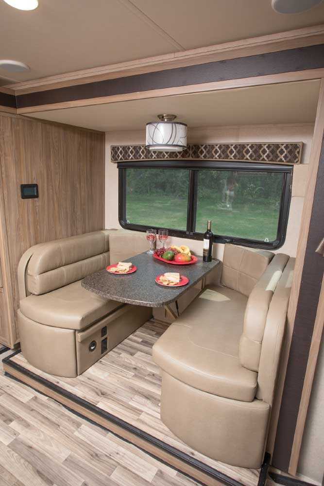 Dream Dinette has thick cushions and bolsters for support when stretching out to watch the TV mounted at the end of the traditional cabover bunk.