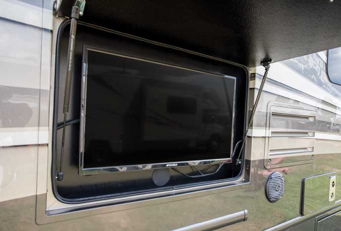 Flush-mounted compartment door hides exterior TV, which can be viewed from the patio. Speakers are mounted in the side wall.