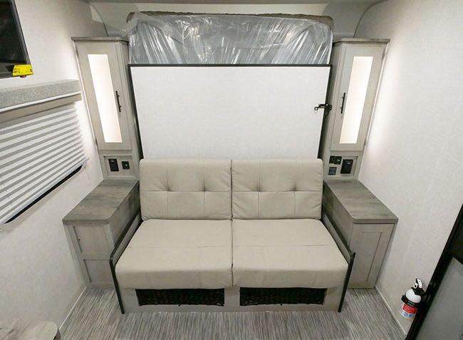 Ibex 19MBH couch with Murphy bed folded up behind it