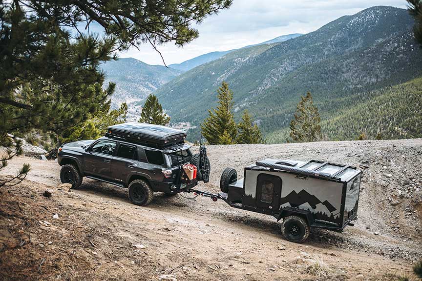 Into the Wild Overland trailer towed off road up a mountain.