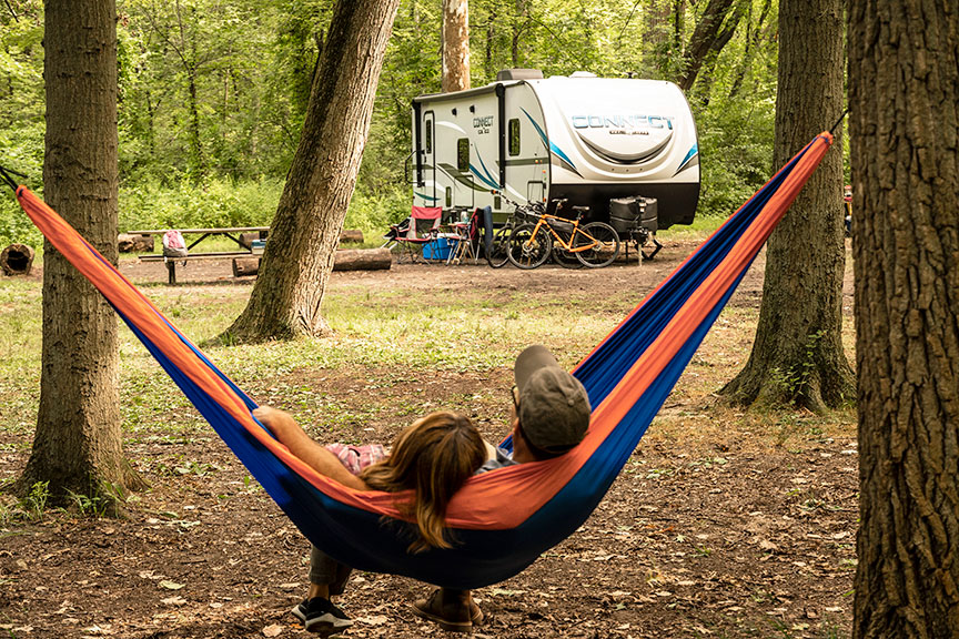 Couple in hammock in front of KZ Connect travel trailer