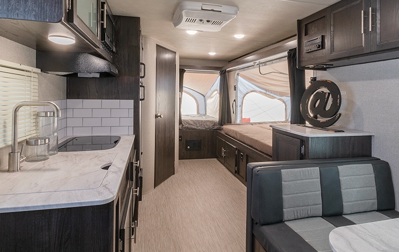 Two tent beds are extended in the rear of the trailer.