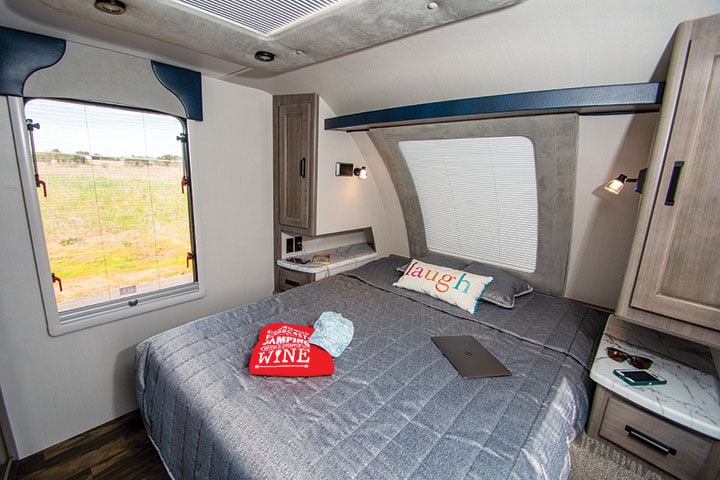 Stargazer window at head of walk-around queen bed in Lance 2075 travel trailer