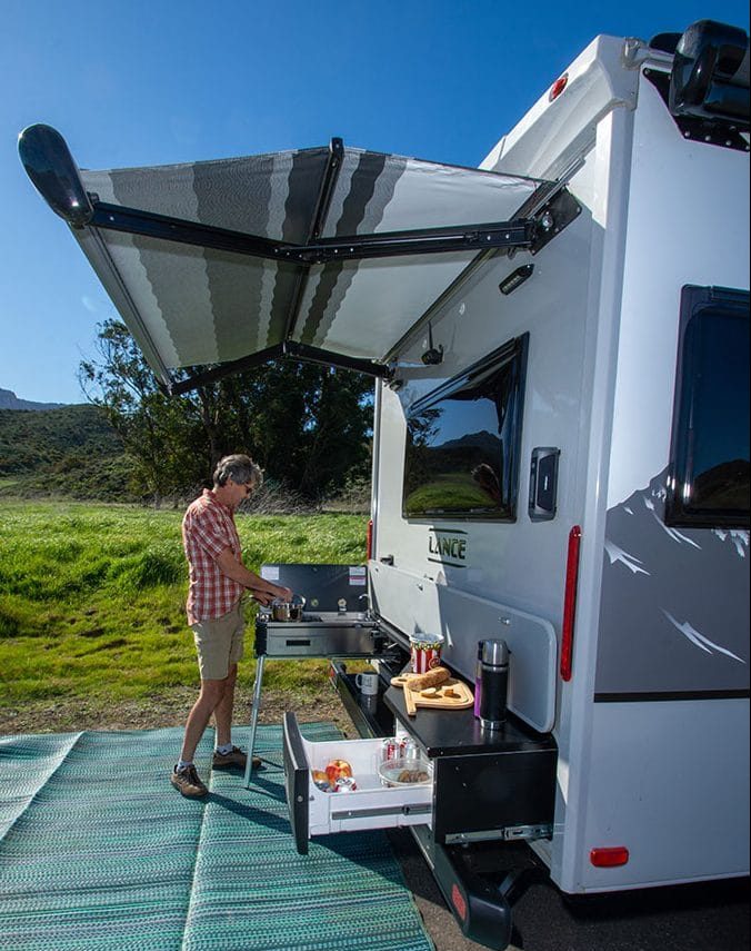 Cooking at stovetop at outdoor kitchen on Lance 2075 travel trailer