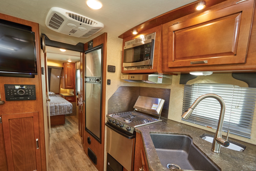 The small but functional galley is nicely appointed and has ample storage for foodstuffs. A hallway leads to the front bedroom with a queen bed.