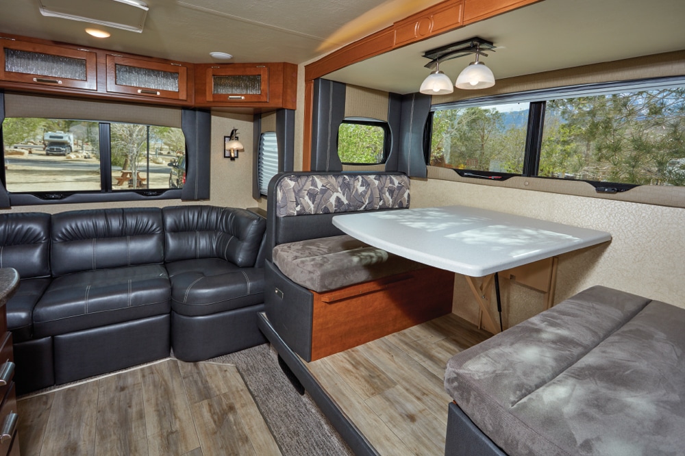 The optional J-couch, in lieu of swivel rockers, is comfortable, but the recliner is restricted by the galley counter. Windows surround the dinette and couch for an open, roomy look.