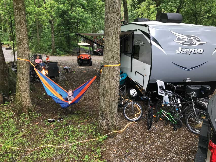 Jayco silver trailer at campground with hammock between trees