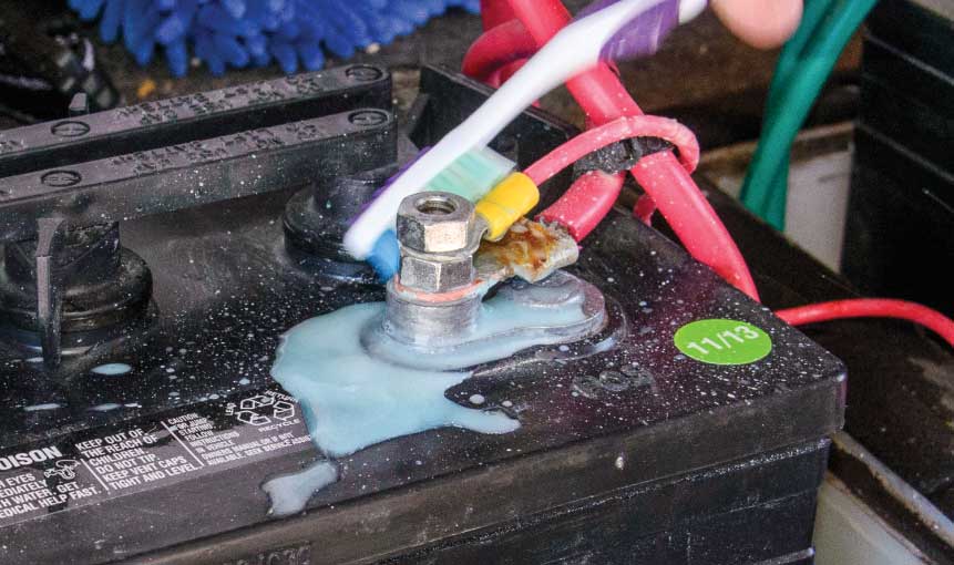 A regular part of wet-cell battery maintenance is cleaning away the corrosion with a solution made from one cup of baking soda per gallon of water. To clean the battery terminals, use a discarded toothbrush or wire-bristle brush with the baking-soda solution, then rinse well. A terminal-cleaning tool can also be used.