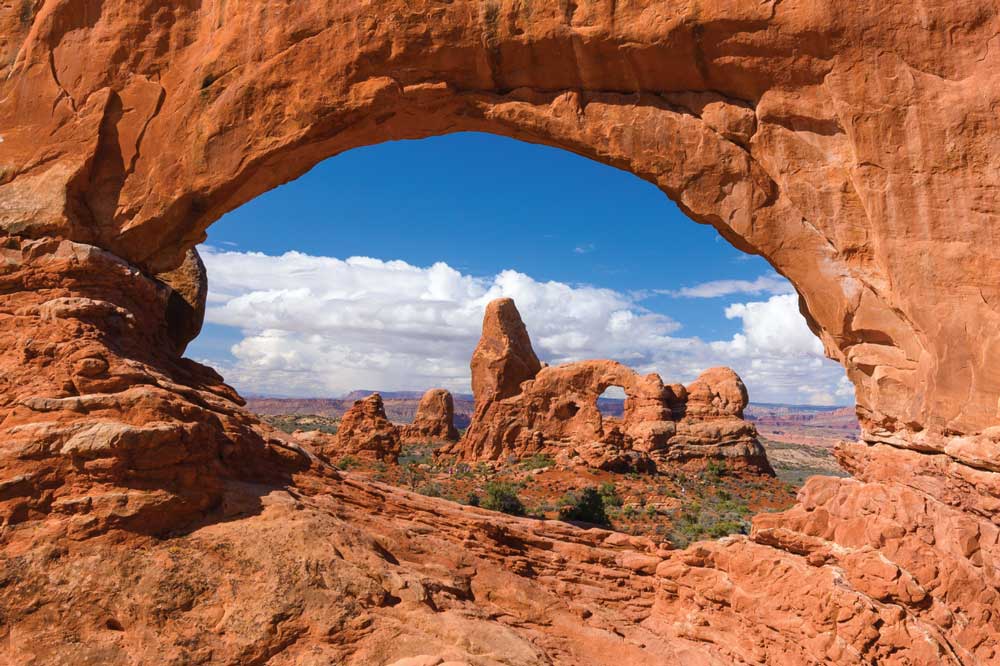window-in-a-window image of Turret Arch framed by North Window at Utah’s Arches National Park.