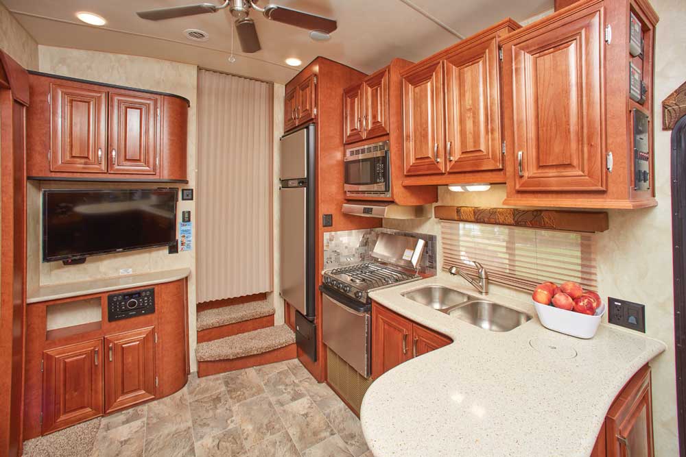 An entertainment center with a 32-inch HDTV and Jensen stereo is incorporated into cabinetry with abundant storage and counter space. The kitchen is set up well for folks who like to cook and entertain. 
