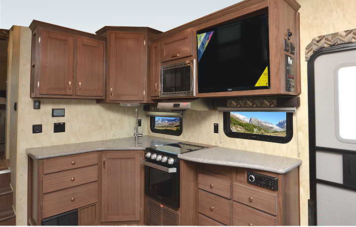 Kitchen cabinets, microwave and oven in Northwood Fox Mountain 265RDS fifth-wheel