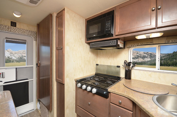 Interior kitchen and entry door of Northwood Wolf Creek 850 truck camper