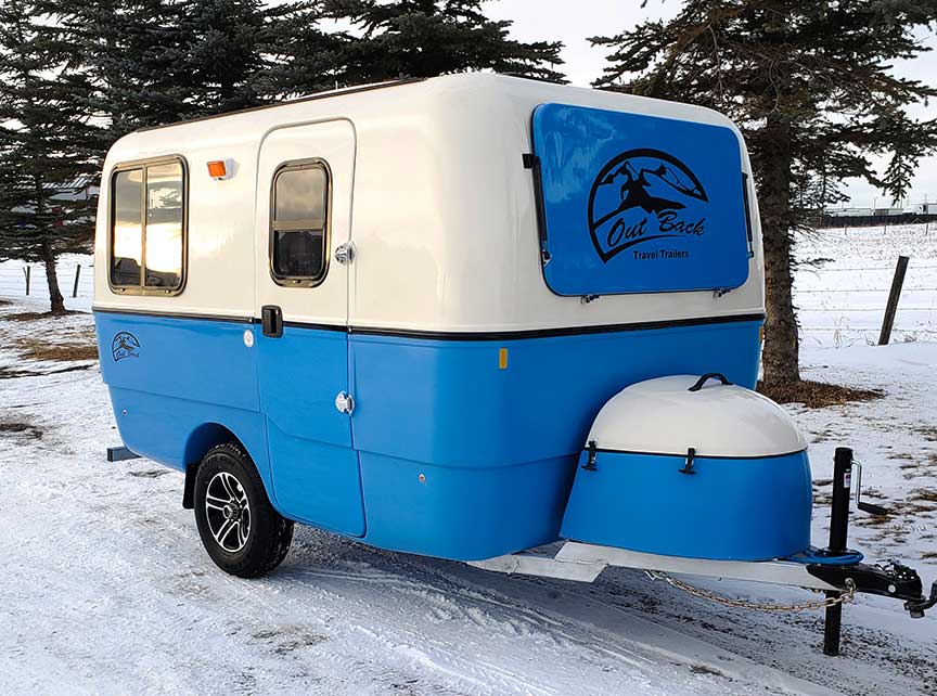 Blue and white fiberglass Trillium trailer in snow.
