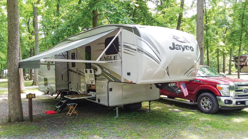 Steve Knoderer's Jayco fifth-wheel with railroad tray tray extended at campsite.