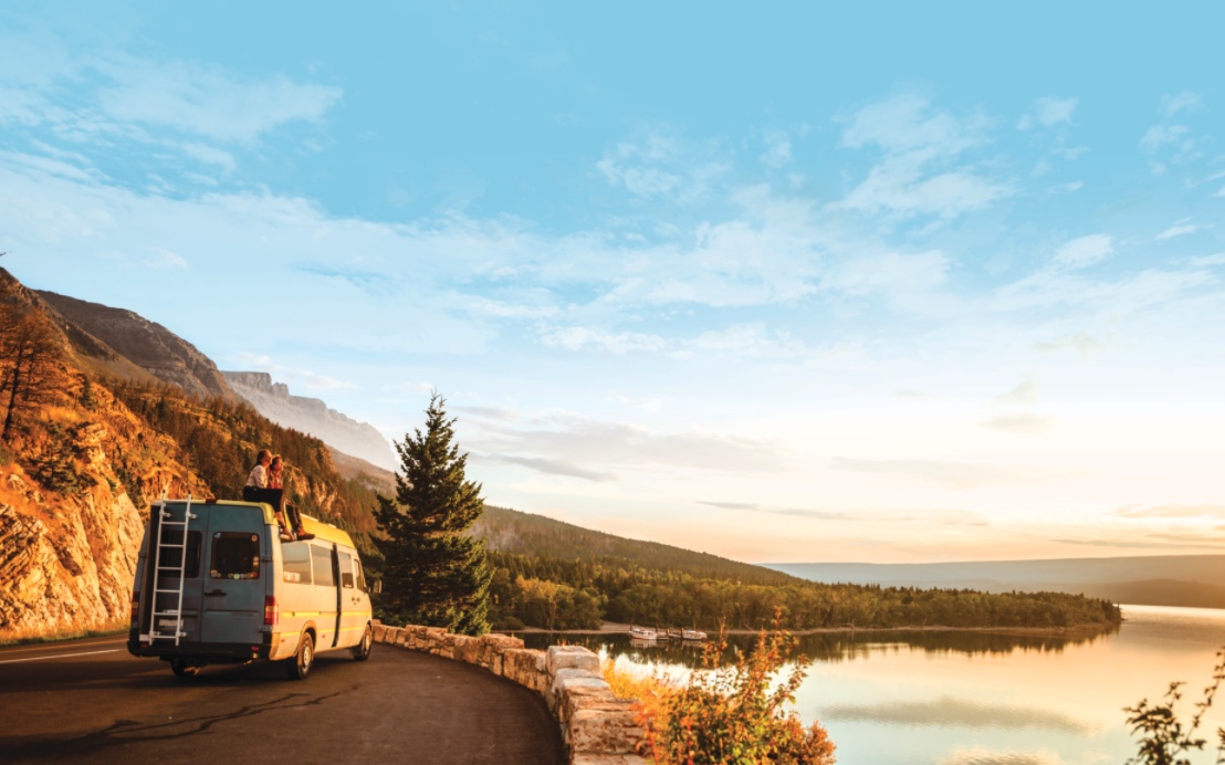 RVers parked at the side of a road overlooking a lake