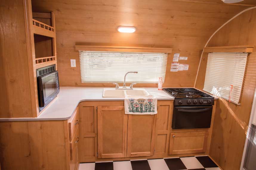  Riverside RV’s Retro 199FKS has a surprisingly spacious kitchen (left) for a smaller trailer. It provides a good amount of counter and shelf space that helps to make up for the absence of overhead cabinets.