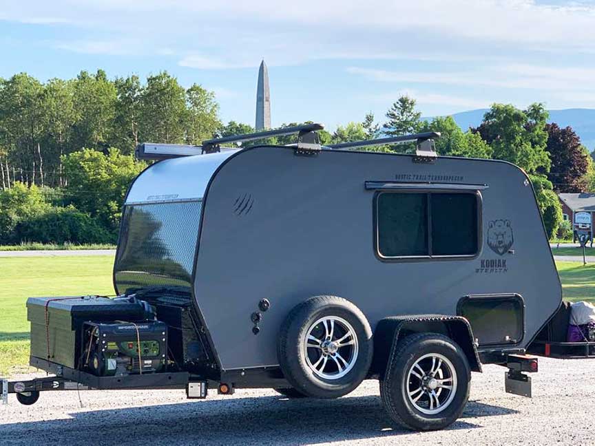 Gray Rustic Trail Kodiak trailer with monument in background.