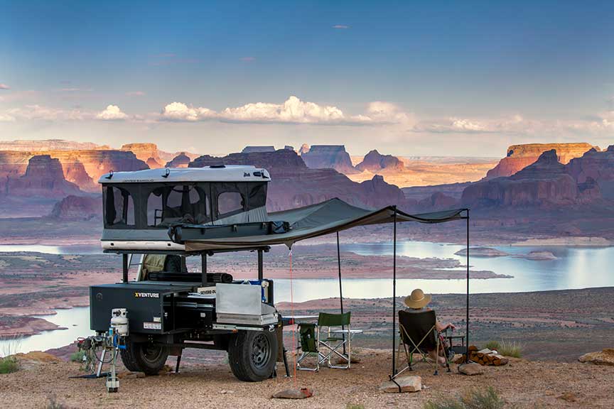 Venture trailer with rooftop tend up and awning extended.